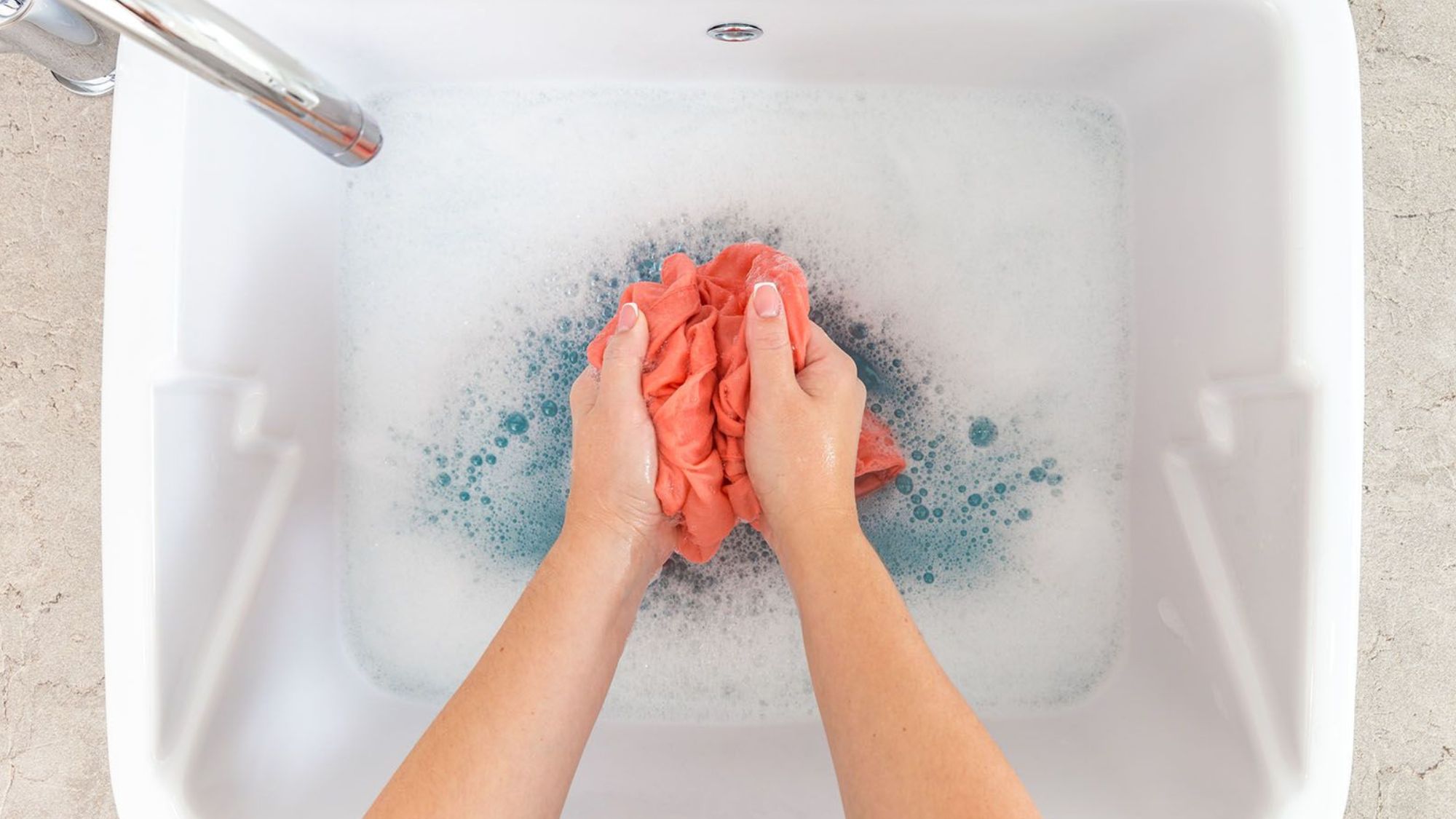 A lady trying to clean and care blankets with hands