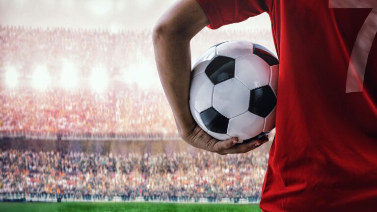 A player holding a football ready for a football match