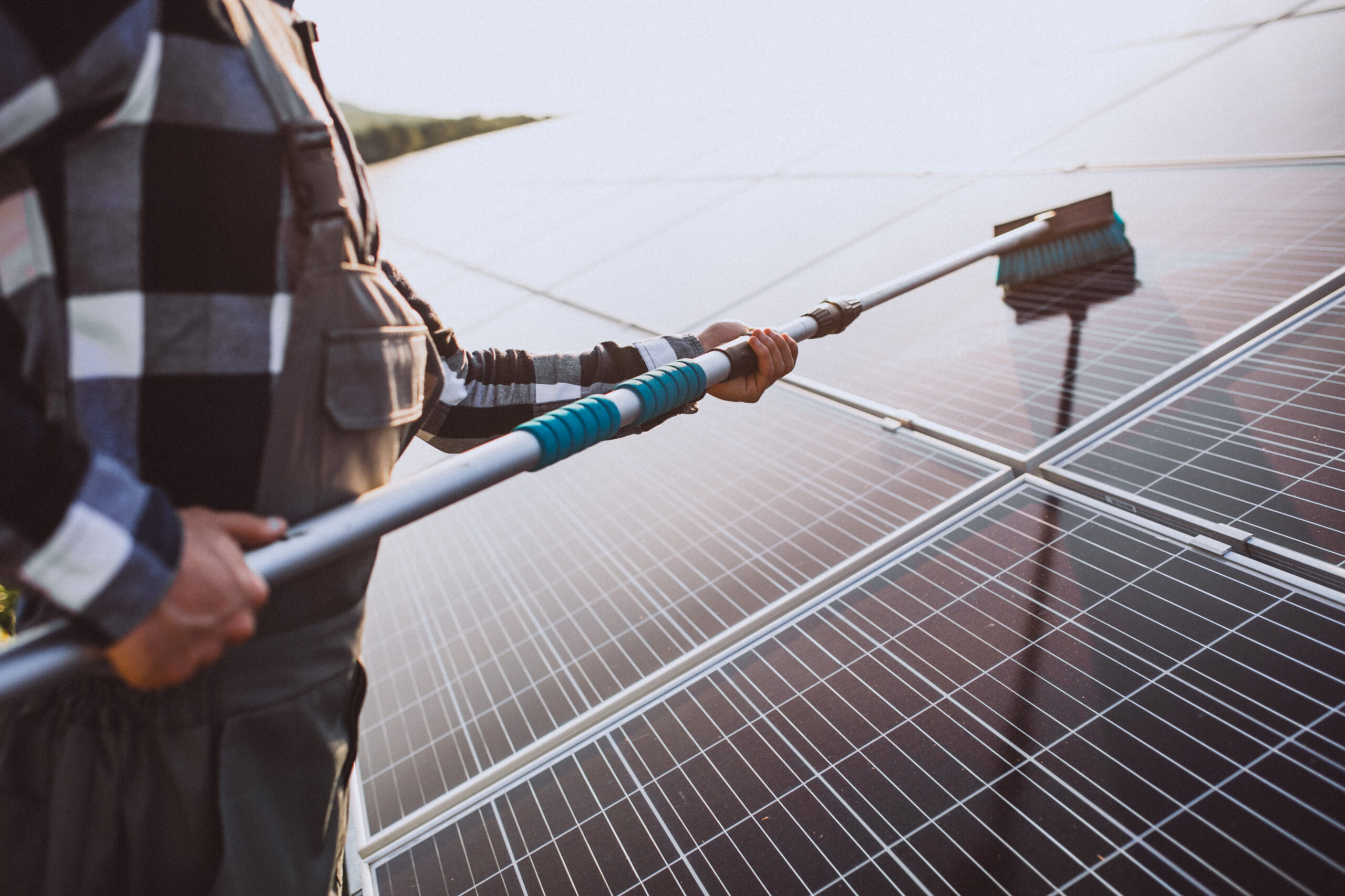 “Professional cleaning of solar panels on a residential rooftop to improve efficiency and maintain energy output.”